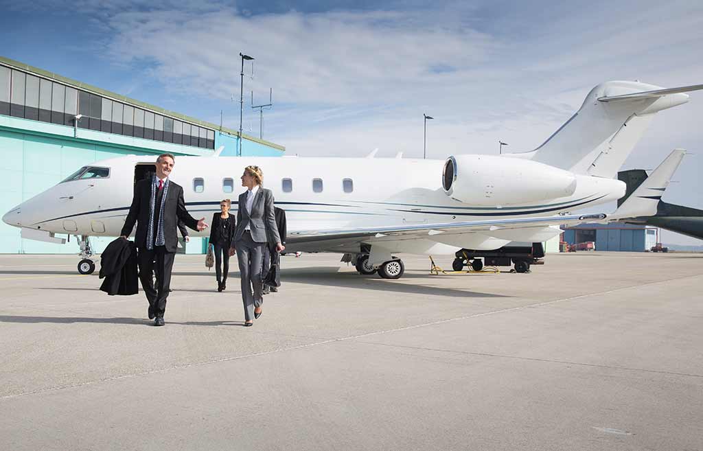 Group of business executives exit a private jet charter flight