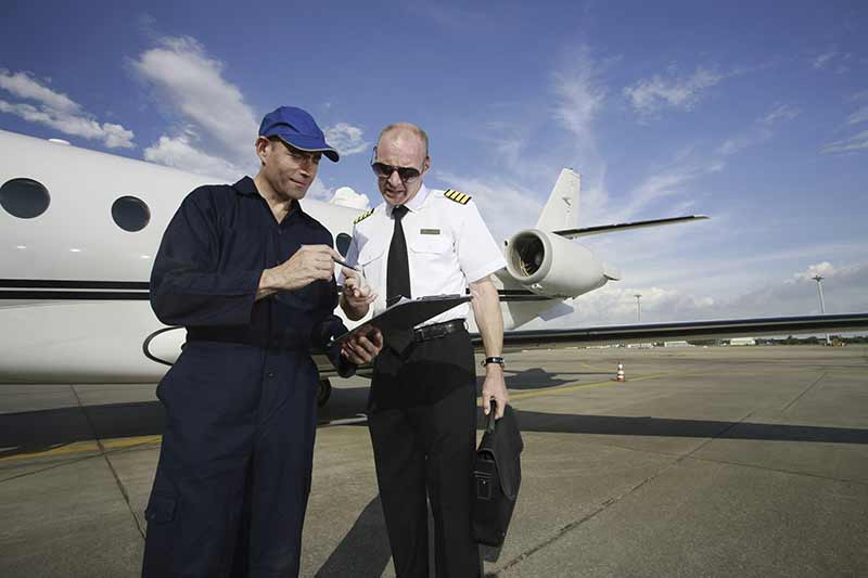 Pilot and ground crew review safety checklist